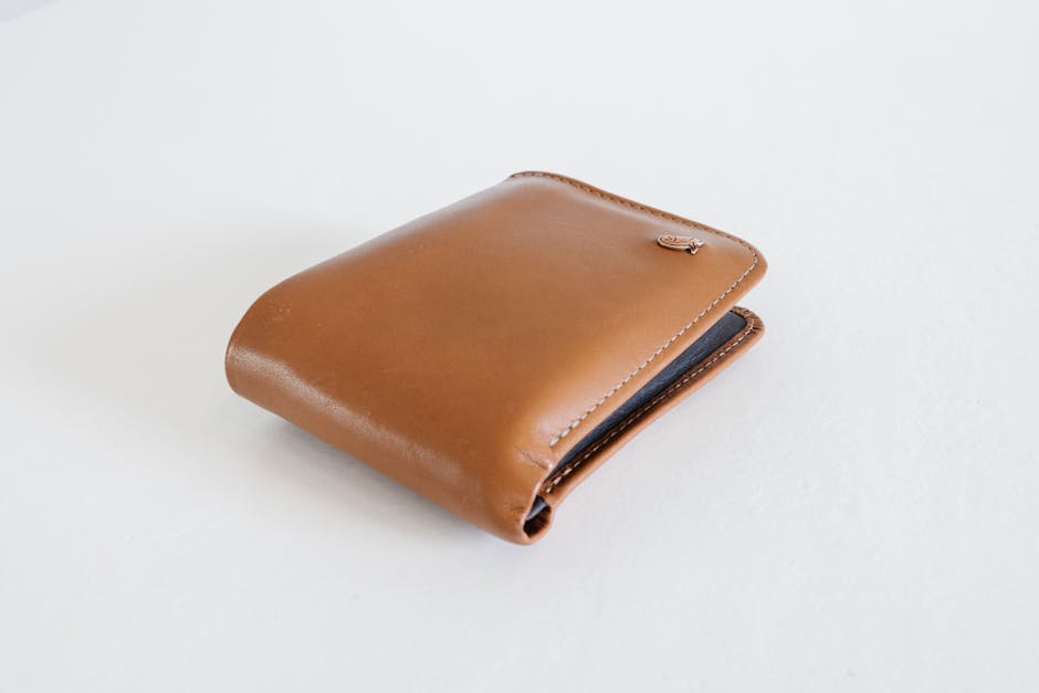 A sleek brown leather wallet photographed against a clean white background, ideal for business use.