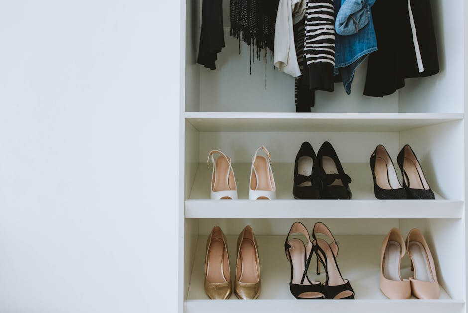 A neatly organized closet with high heels and assorted clothes on shelves.